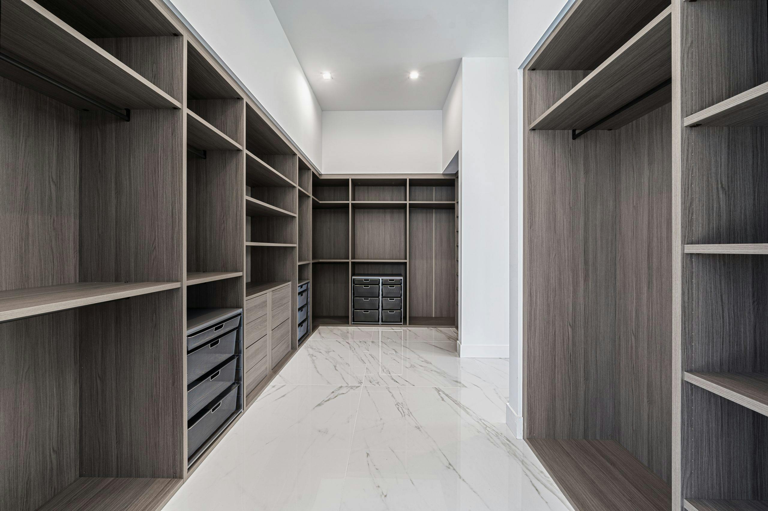 Interior of light apartment with wooden cabinet with empty shelves next to bed